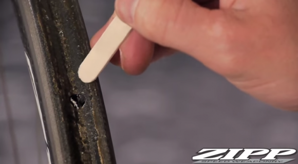Use a soft tool to remove tubular glue from rim.
